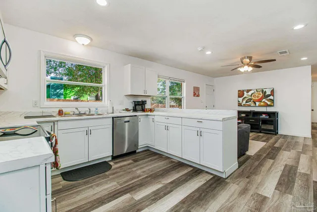 a kitchen with a sink window and cabinets