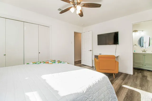 a bedroom with a bed and a flat screen tv