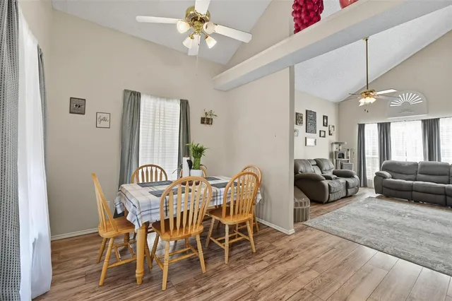 a view of a dining room with furniture and wooden floor