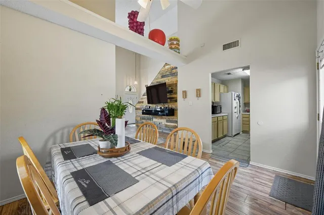a view of a dining room with furniture a chandelier and wooden floor