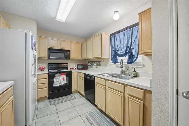 a kitchen with stainless steel appliances granite countertop a refrigerator sink and cabinets
