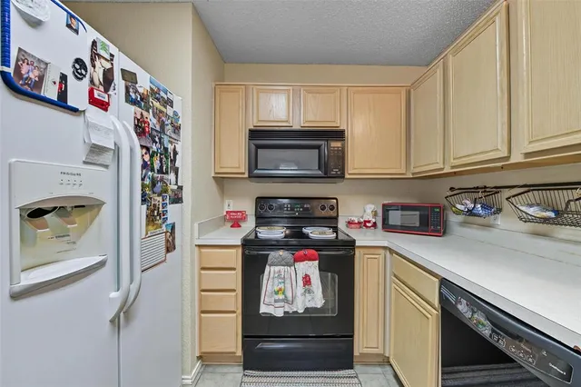 a kitchen with kitchen island granite countertop a sink stainless steel appliances and cabinets