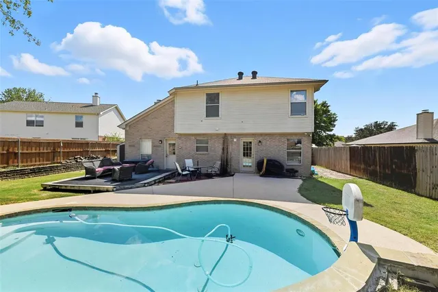 an outdoor sitting area with furniture and wooden floor