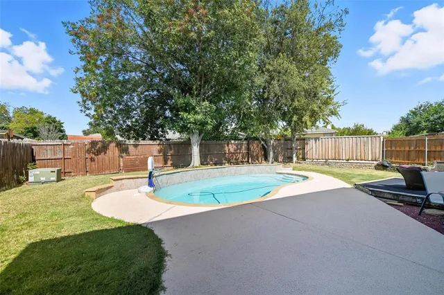 a view of a backyard with swimming pool