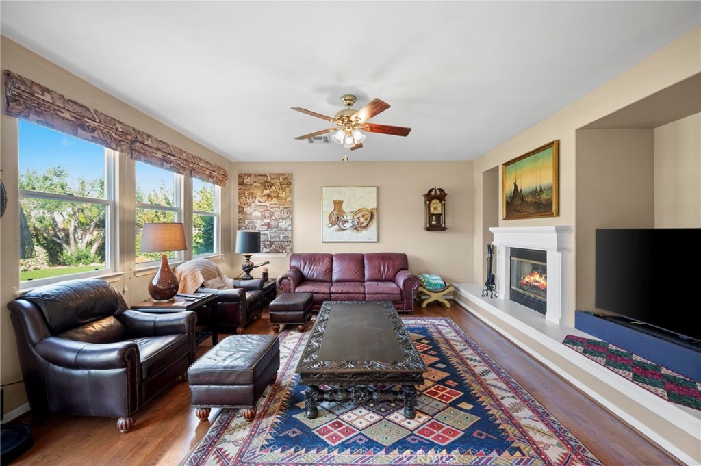 3262 Bluebird Circle Simi Valley, CA 93063 - Photo 11 of 43 a living room with furniture a flat screen tv and a fireplace