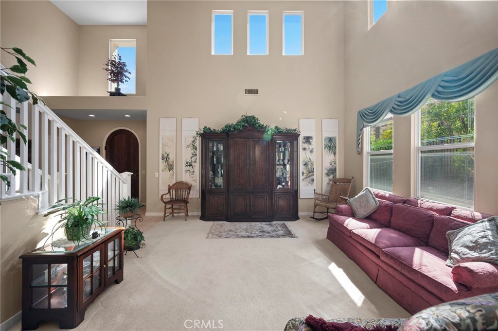 3262 Bluebird Circle Simi Valley, CA 93063 - Photo 6 of 43 a living room with furniture a fireplace and a large window