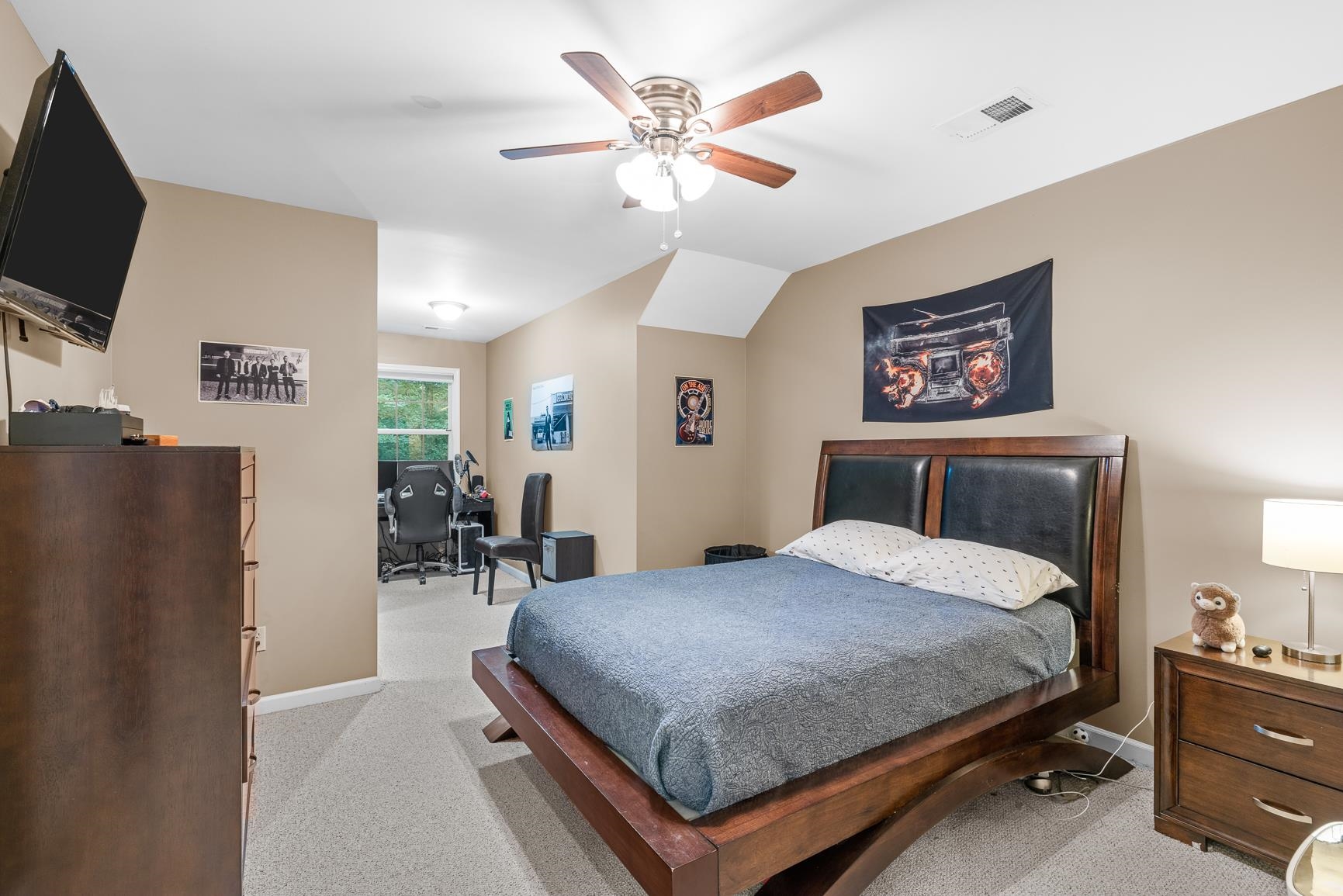 8240 Brunswick Road Millington, TN 38053 - Photo 22 of 25 a bedroom with a bed a dresser and a flat screen tv