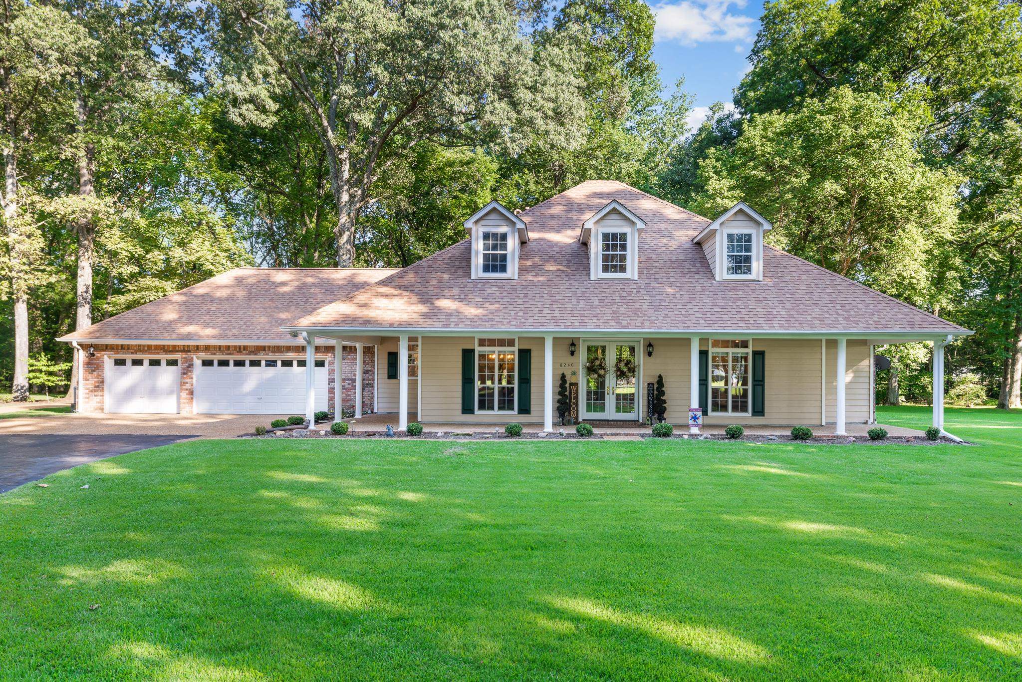 8240 Brunswick Road Millington, TN 38053 - Photo 3 of 25 a front view of a house with a yard and green space