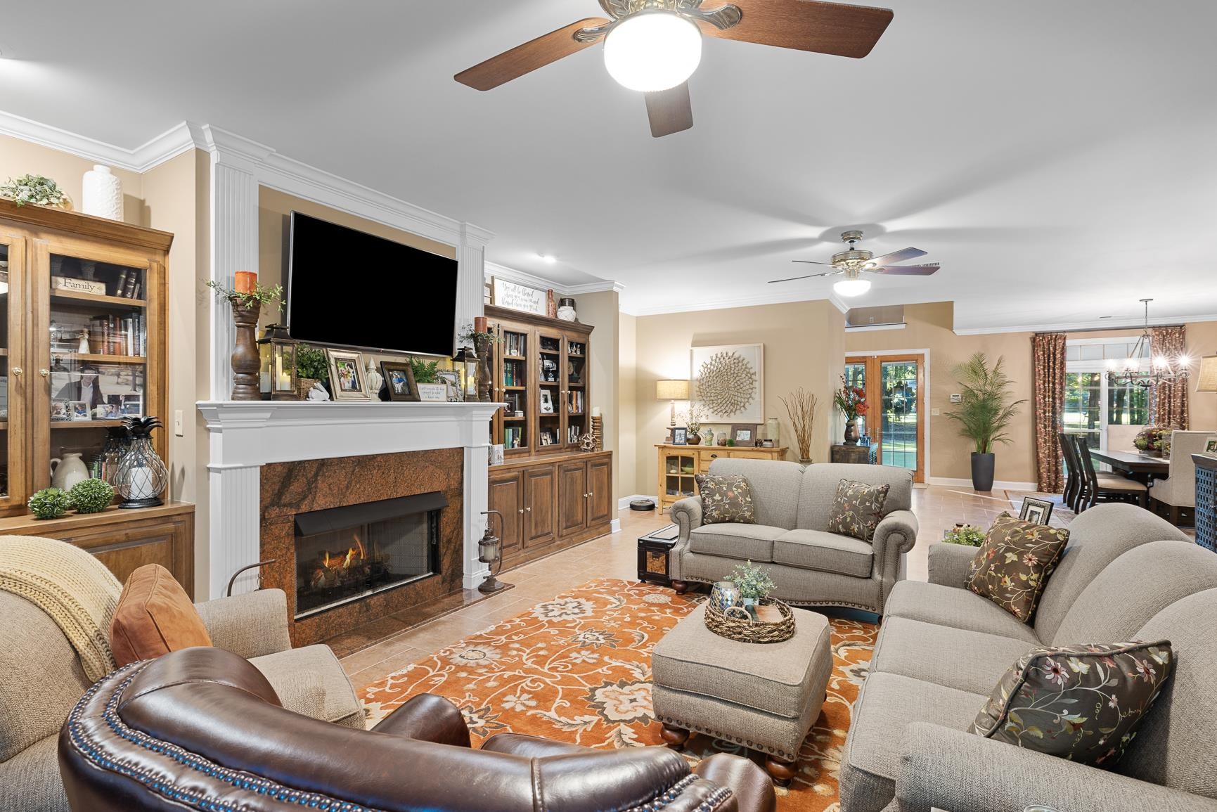 8240 Brunswick Road Millington, TN 38053 - Photo 9 of 25 a living room with furniture a flat screen tv and a fireplace