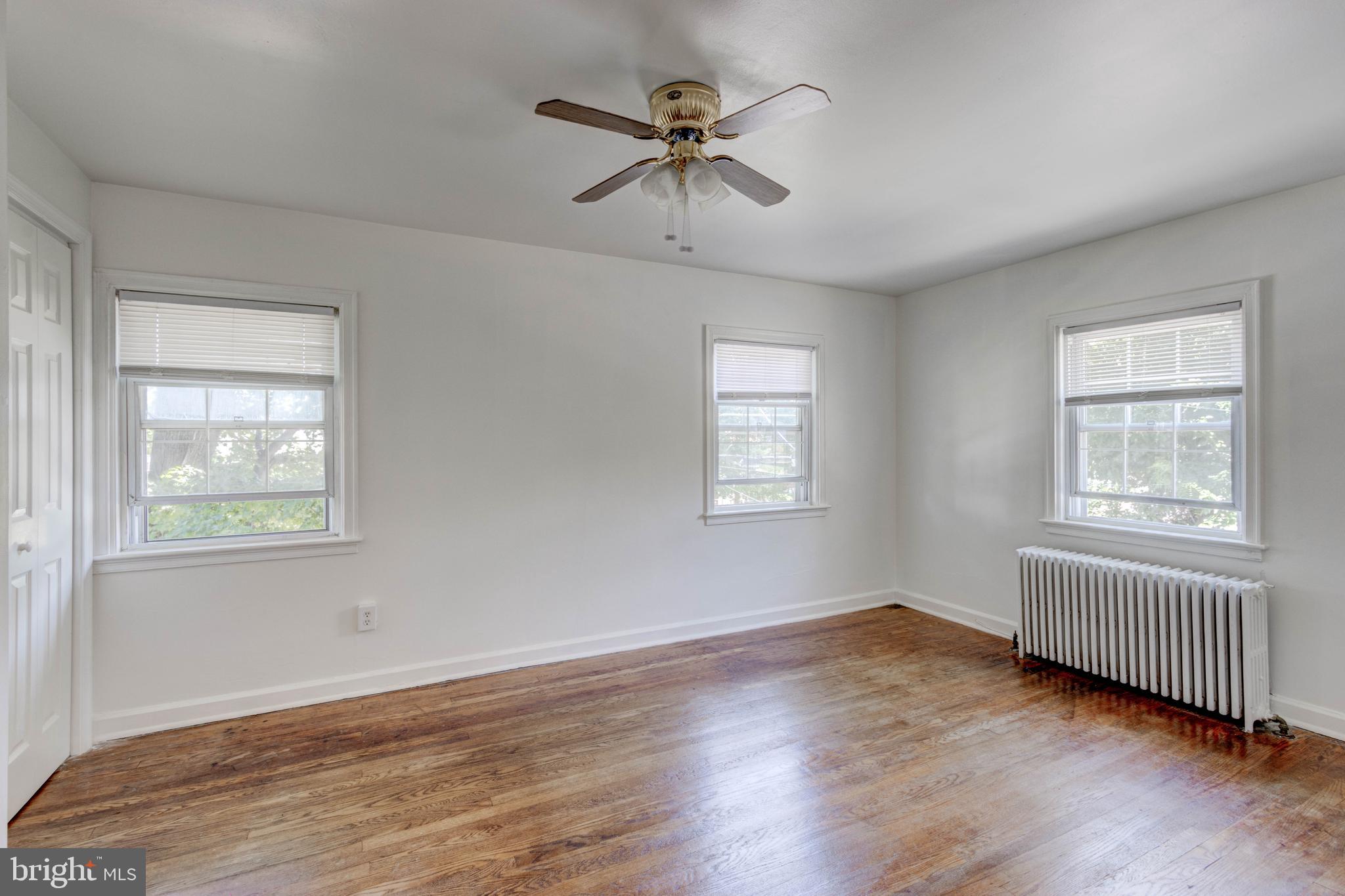 523 Academy Road Catonsville, MD 21228 - Photo 12 of 26 a view of an empty room with wooden floor and a window