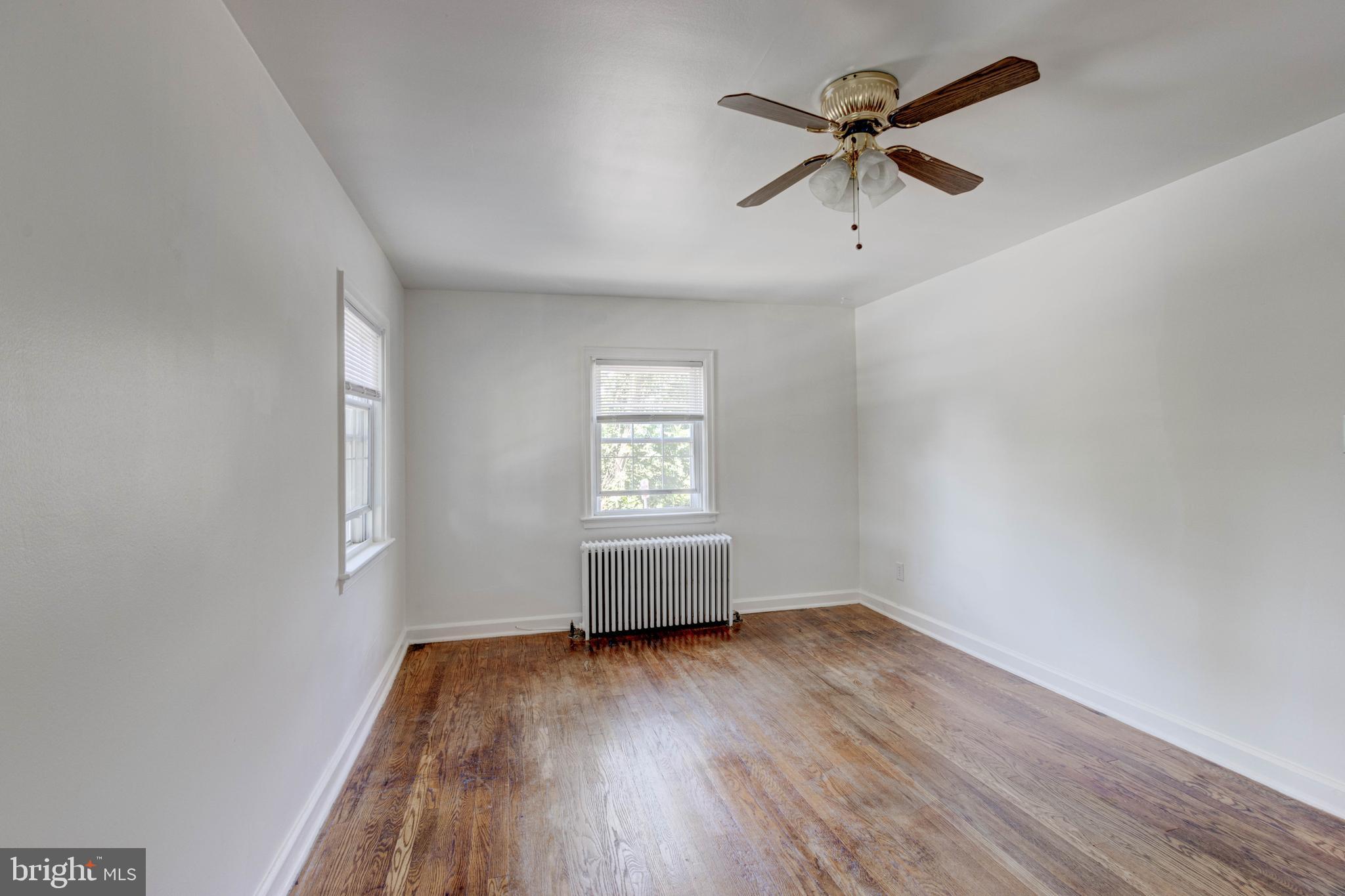 523 Academy Road Catonsville, MD 21228 - Photo 13 of 26 an empty room with wooden floor and windows