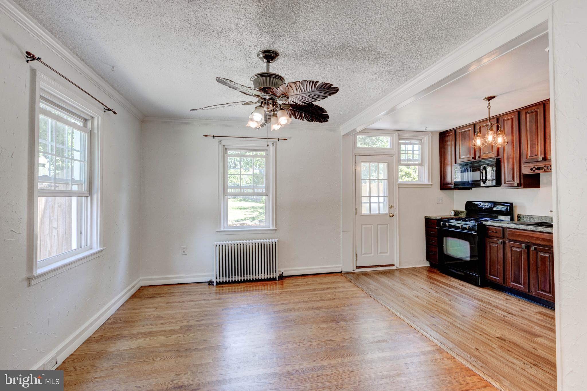 523 Academy Road Catonsville, MD 21228 - Photo 5 of 26 a kitchen with granite countertop stainless steel appliances cabinets a stove and a window