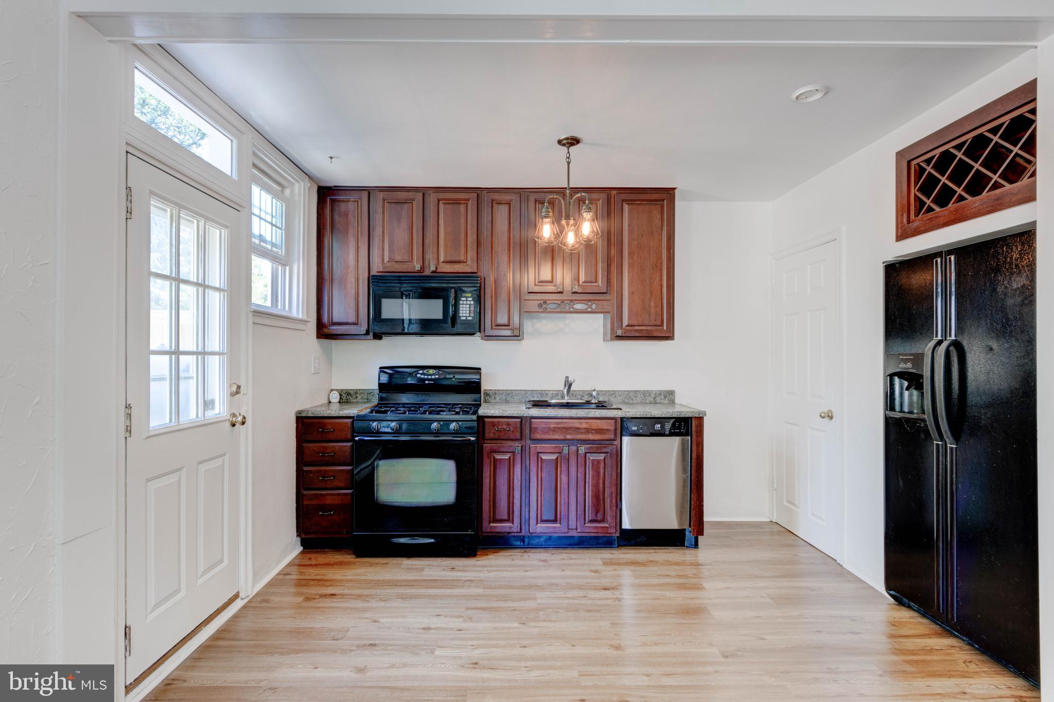 523 Academy Road Catonsville, MD 21228 - Photo 8 of 26 a kitchen with stainless steel appliances granite countertop a refrigerator stove and sink