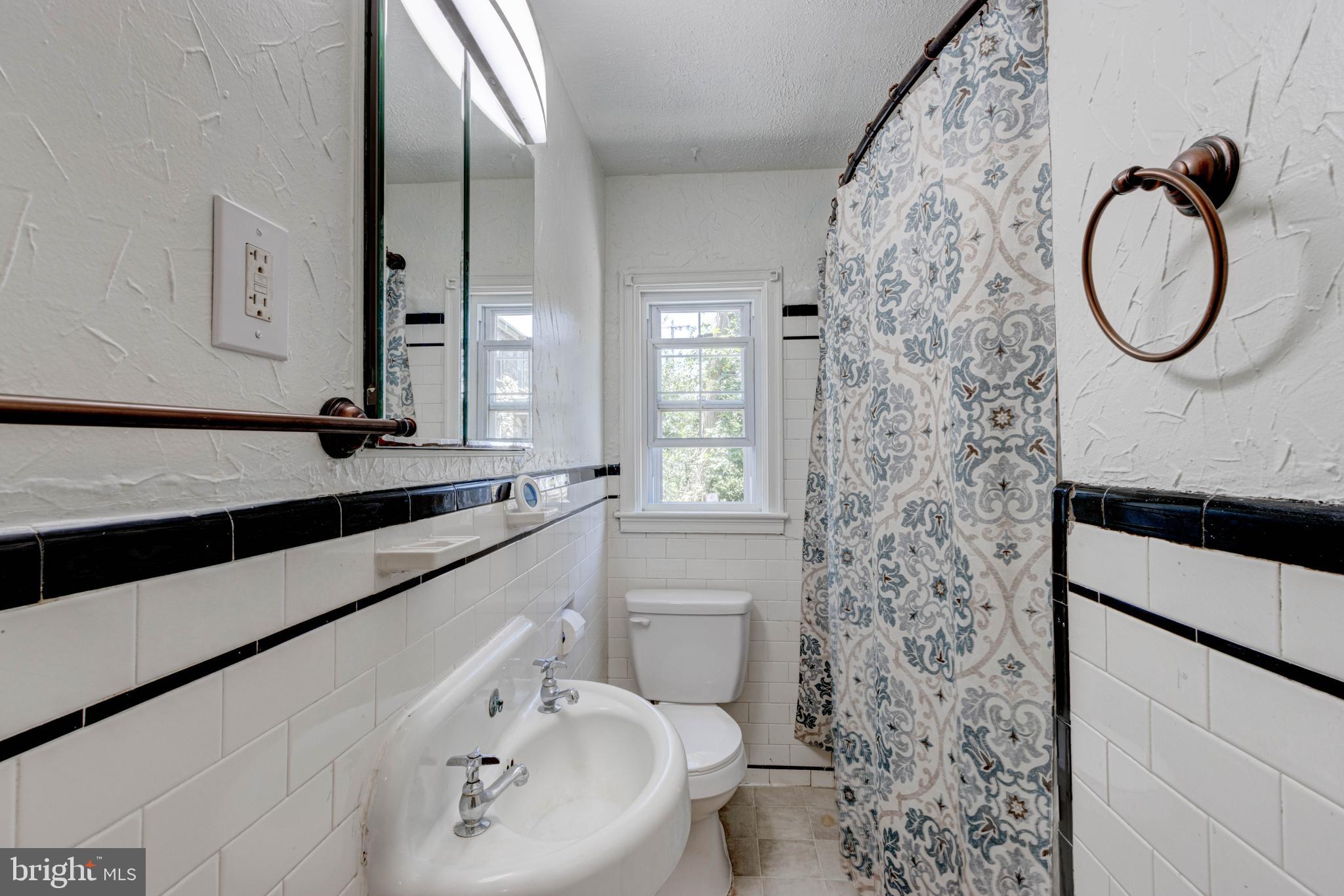 523 Academy Road Catonsville, MD 21228 - Photo 10 of 26 a bathroom with a sink and a mirror