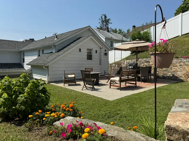 a view of a house with backyard sitting area and garden