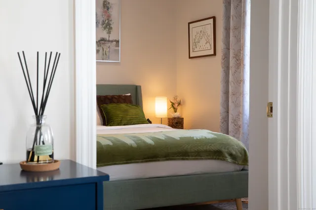 a bedroom with a bed and a flat tv screen