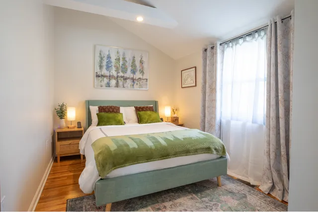 a bedroom with a bed and a window