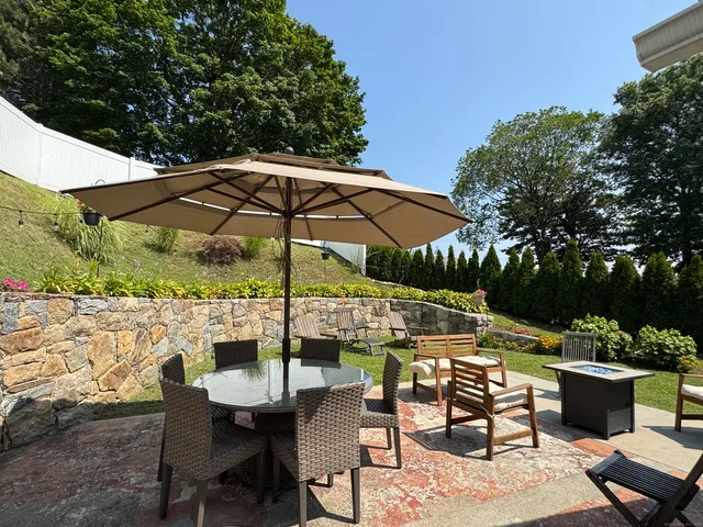 a view of table and chairs under an umbrella