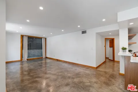 a kitchen with stainless steel appliances a sink and a refrigerator