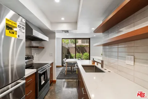 a kitchen with a sink and wooden cabinets