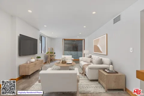 a bedroom with a large bed and a flat screen tv