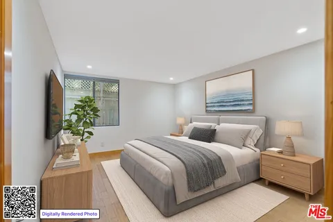 a bedroom with a large bed and a flat screen tv