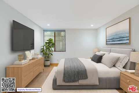 a bedroom with a large bed and a flat screen tv