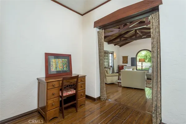 a bedroom with furniture and a wooden floor