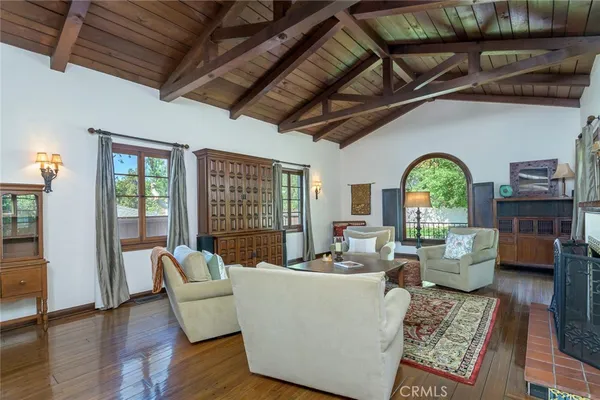 a view of a livingroom with wooden floor and a window