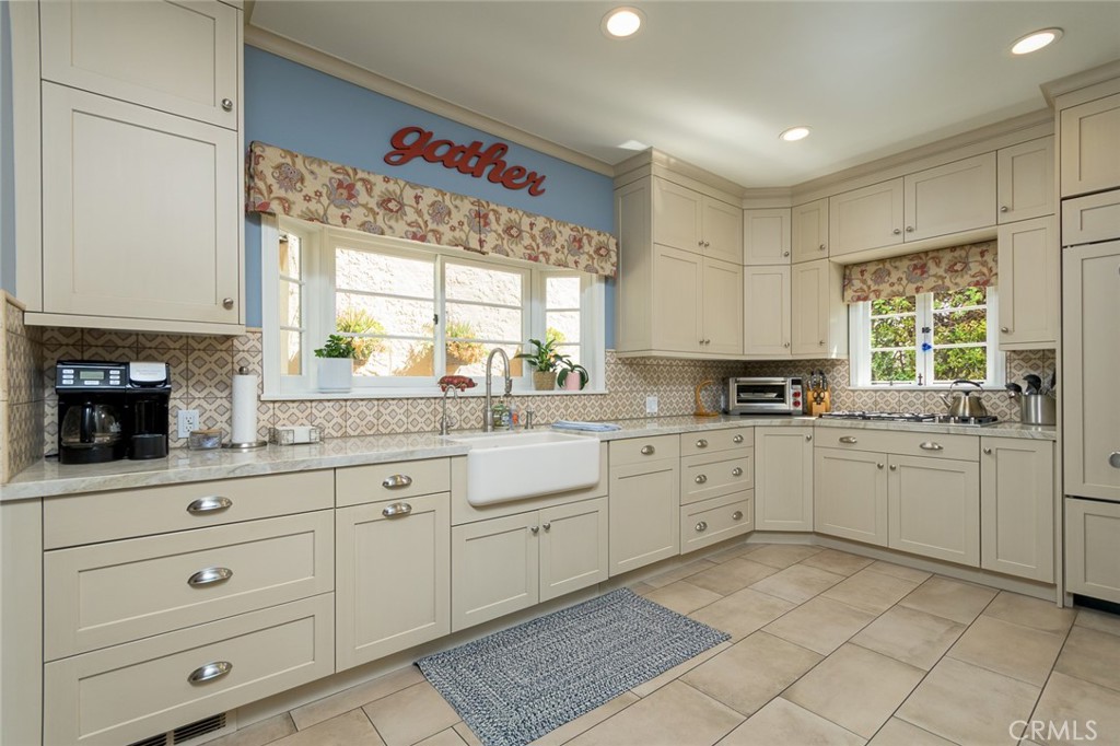 752 Glenview Road Glendale, CA 91202 - Photo 23 of 64 a kitchen with granite countertop white cabinets stainless steel appliances a sink and a window