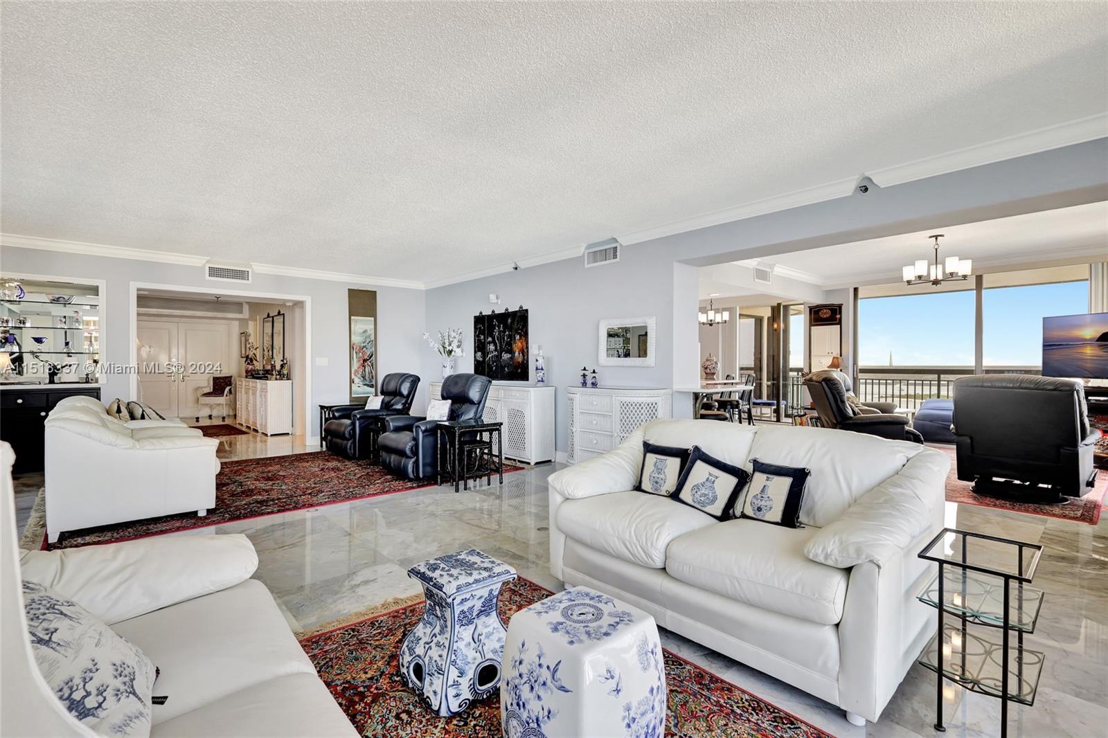 5380 North Ocean Drive, Unit 22J Riviera Beach, FL 33404 - Photo 11 of 83 a living room with furniture and a flat screen tv