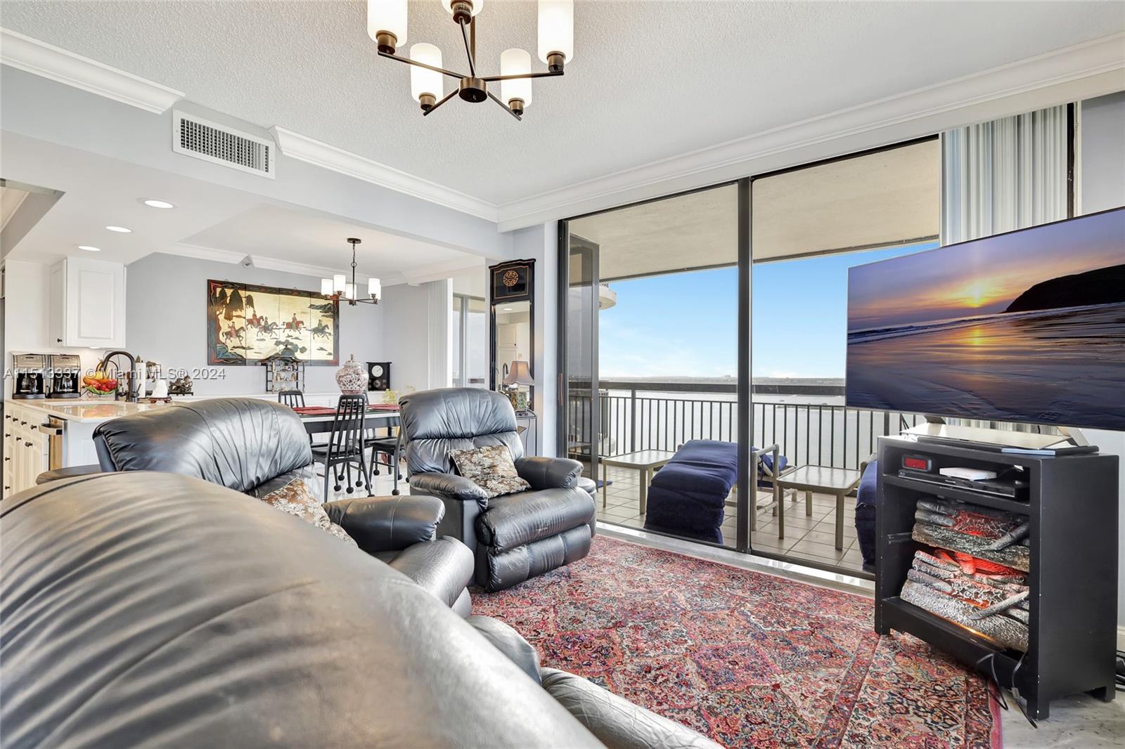 5380 North Ocean Drive, Unit 22J Riviera Beach, FL 33404 - Photo 17 of 83 a living room with furniture ceiling fan and a rug
