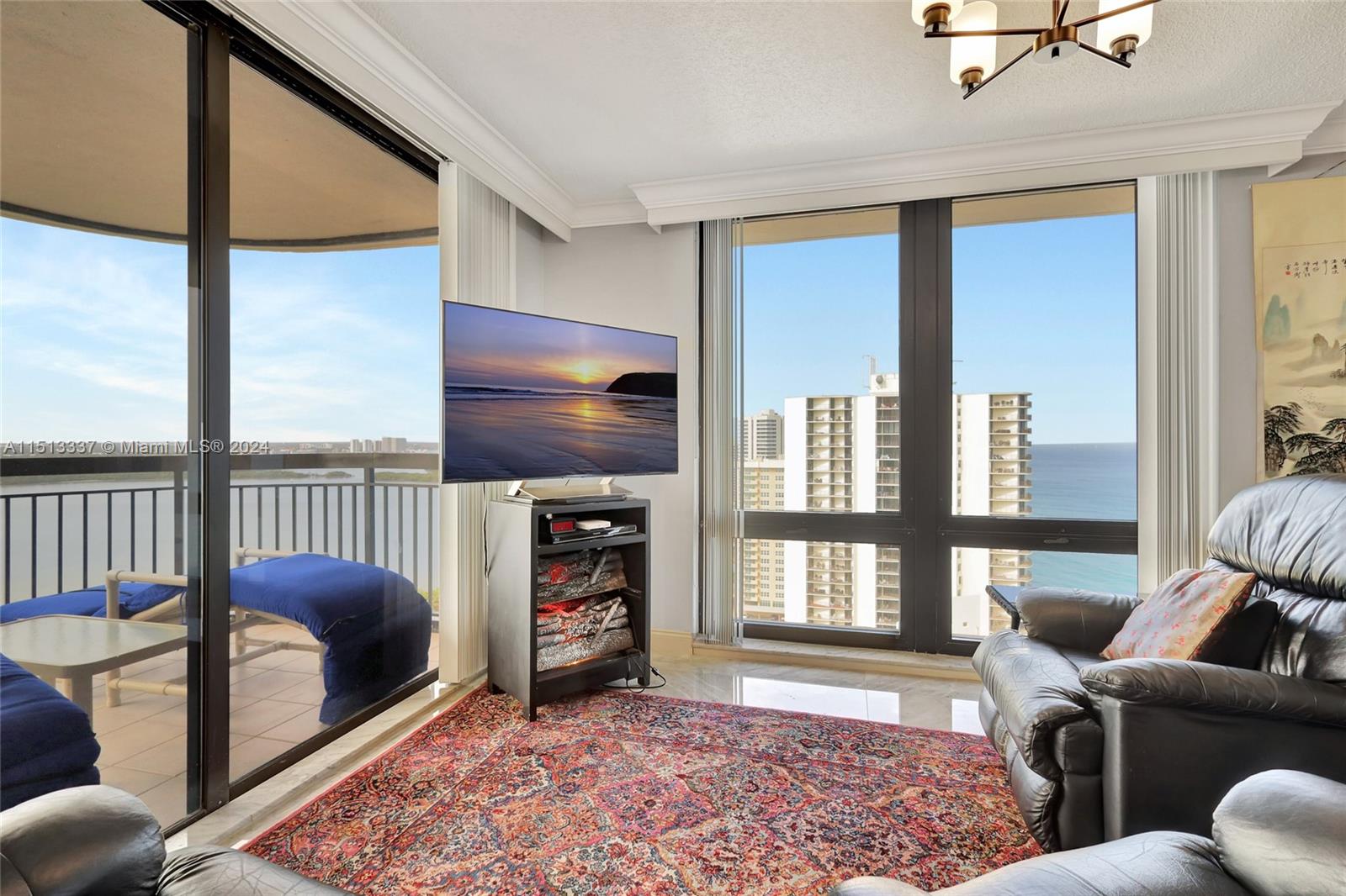 5380 North Ocean Drive, Unit 22J Riviera Beach, FL 33404 - Photo 19 of 83 a living room with furniture a flat screen tv and a window