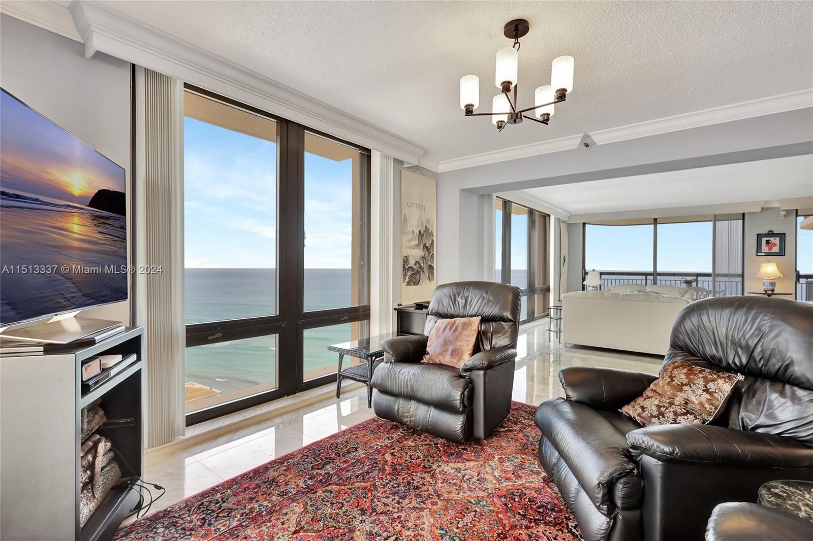 5380 North Ocean Drive, Unit 22J Riviera Beach, FL 33404 - Photo 21 of 83 a living room with furniture and a fireplace