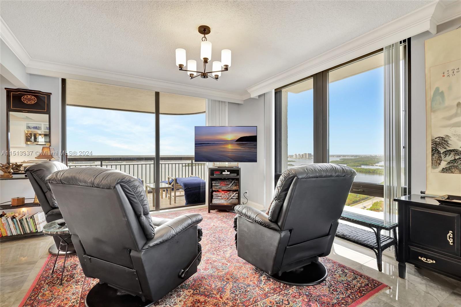 5380 North Ocean Drive, Unit 22J Riviera Beach, FL 33404 - Photo 23 of 83 a living room with furniture a flat screen tv and large windows