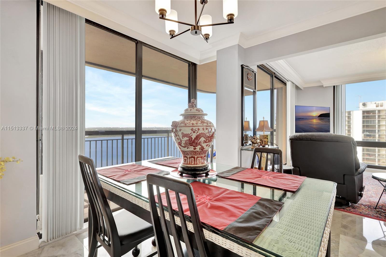 5380 North Ocean Drive, Unit 22J Riviera Beach, FL 33404 - Photo 26 of 83 a dining room with furniture a chandelier and window
