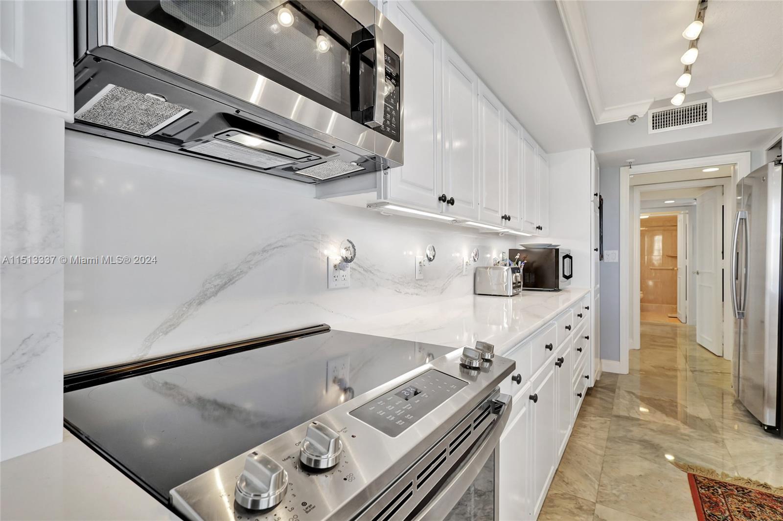 5380 North Ocean Drive, Unit 22J Riviera Beach, FL 33404 - Photo 34 of 83 a kitchen with stainless steel appliances cabinets and a counter top space
