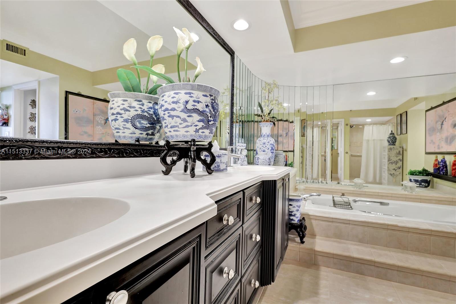 5380 North Ocean Drive, Unit 22J Riviera Beach, FL 33404 - Photo 38 of 83 a spacious bathroom with a sink a bathtub and a mirror