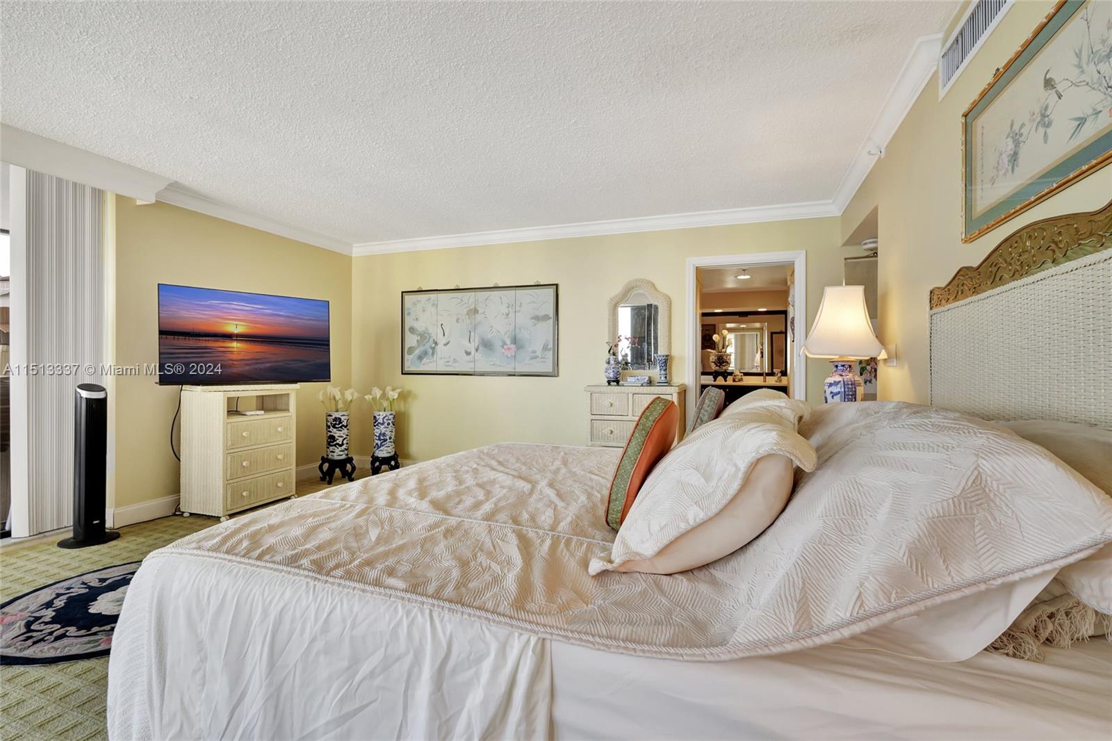5380 North Ocean Drive, Unit 22J Riviera Beach, FL 33404 - Photo 46 of 83 a bedroom with a bed and a flat screen tv