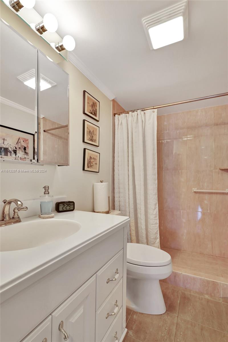5380 North Ocean Drive, Unit 22J Riviera Beach, FL 33404 - Photo 52 of 83 a bathroom with a sink a toilet and mirror