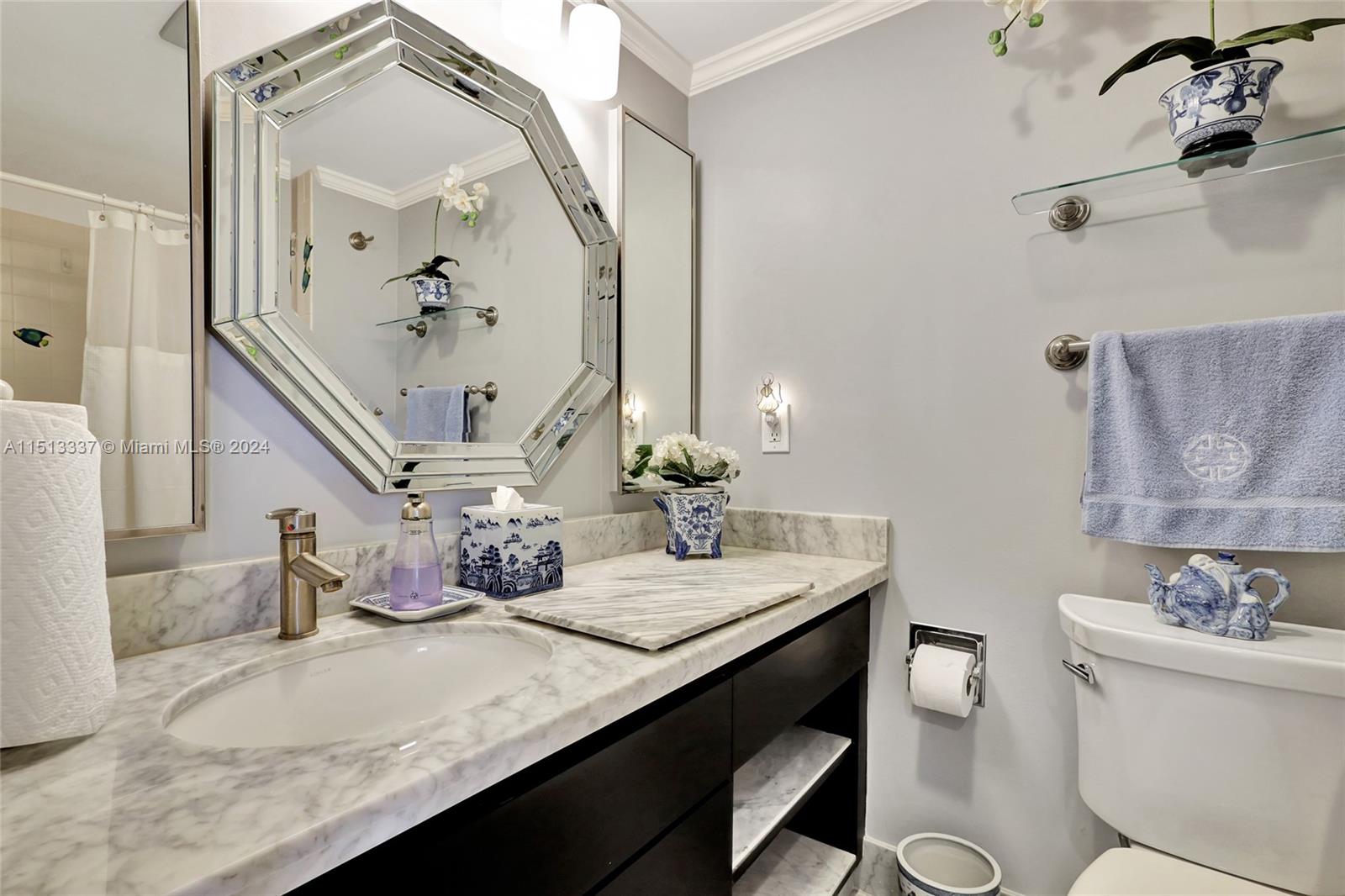 5380 North Ocean Drive, Unit 22J Riviera Beach, FL 33404 - Photo 55 of 83 a bathroom with a granite countertop sink a toilet and a mirror