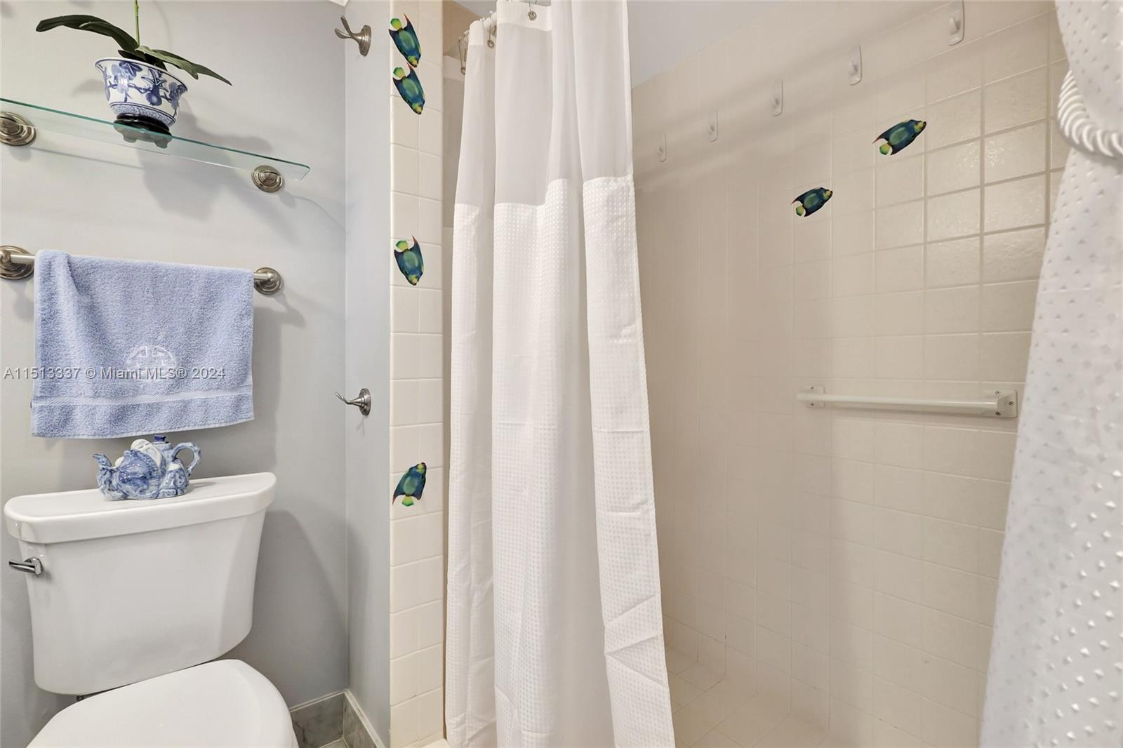 5380 North Ocean Drive, Unit 22J Riviera Beach, FL 33404 - Photo 56 of 83 a white toilet sitting next to a bathroom sink