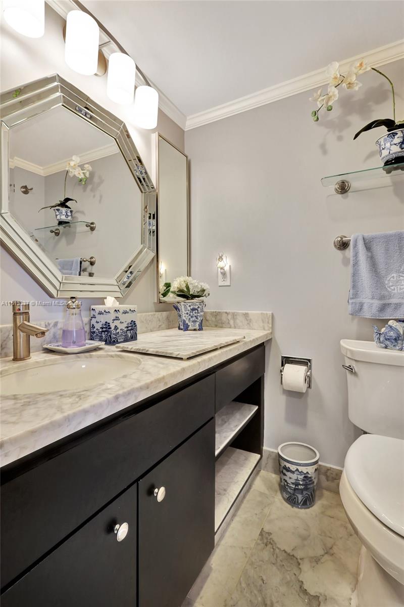 5380 North Ocean Drive, Unit 22J Riviera Beach, FL 33404 - Photo 58 of 83 a bathroom with a granite countertop sink mirror and toilet