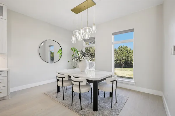 a view of a dining room with furniture and chandelier