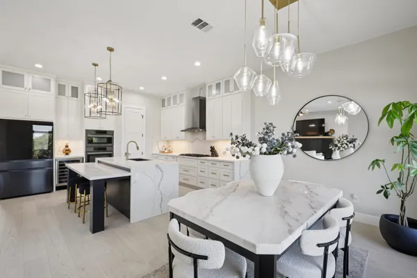 a view of a dining room with furniture wooden floor and chandelier