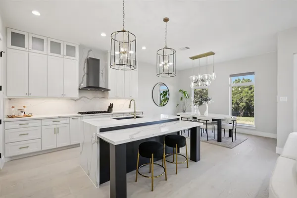 a kitchen with kitchen island granite countertop a sink a center island and cabinets