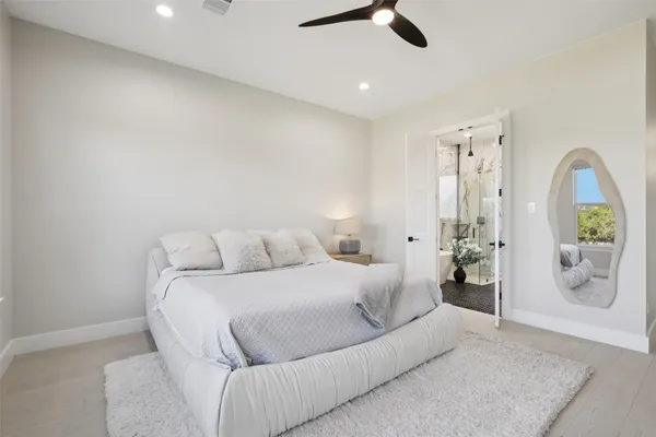 a bedroom with a large bed and a window