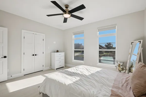 a bedroom with a bed and a large window