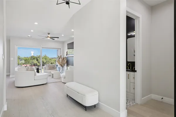 a living room with furniture and a hallway