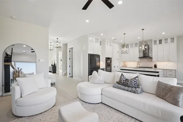 a living room with furniture and a view of kitchen